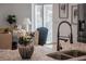 Close-up of the kitchen island with granite countertops, modern faucet, and decorative vase at 225 Diesel Rd, Mulberry, FL 33860