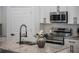 Close-up of the kitchen island with granite countertops and stainless steel appliances at 225 Diesel Rd, Mulberry, FL 33860