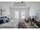 Main bedroom featuring tray ceiling, accent rugs, desk, chair and big windows at 225 Diesel Rd, Mulberry, FL 33860