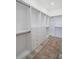 Spacious walk-in closet with gray toned wood floors, built-in storage shelves, and closet rods at 225 Diesel Rd, Mulberry, FL 33860