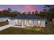 Beautiful exterior of home with landscaping and a lovely pink sky at dusk at 15499 Sw 27Th Ln, Ocala, FL 34481