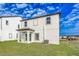 Home's backyard with covered patio and grassy area at 3728 Bergamot St, Lake Alfred, FL 33850
