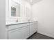 Modern bathroom with double vanity and white cabinets at 3728 Bergamot St, Lake Alfred, FL 33850
