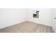 Bright bedroom with carpeted floor and window view at 3728 Bergamot St, Lake Alfred, FL 33850