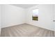 Spacious bedroom with window and carpeted floor at 3728 Bergamot St, Lake Alfred, FL 33850
