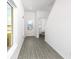 Bright entryway with gray vinyl flooring and powder room at 3728 Bergamot St, Lake Alfred, FL 33850