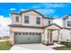 Two-story home with gray garage door and landscaping at 3728 Bergamot St, Lake Alfred, FL 33850
