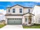 Two-story house with gray garage door and landscaping at 3728 Bergamot St, Lake Alfred, FL 33850