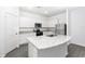 Kitchen with white cabinets, granite island and stainless appliances at 3728 Bergamot St, Lake Alfred, FL 33850