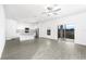 Open living room and kitchen with gray vinyl flooring at 3728 Bergamot St, Lake Alfred, FL 33850