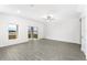Living room with sliding glass doors and gray vinyl flooring at 3728 Bergamot St, Lake Alfred, FL 33850