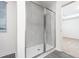 Clean shower with glass enclosure and grey tile at 3728 Bergamot St, Lake Alfred, FL 33850