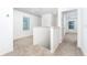Upstairs hallway with carpet, window, and access to bedrooms at 3728 Bergamot St, Lake Alfred, FL 33850