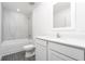 Bathroom with white vanity, tub, and gray tile flooring at 3740 Bergamot St, Lake Alfred, FL 33850
