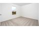 Well-lit bedroom with carpet and a window offering an outdoor view at 3740 Bergamot St, Lake Alfred, FL 33850