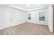Bright bedroom with neutral carpeting and two windows at 3740 Bergamot St, Lake Alfred, FL 33850