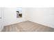 Bright bedroom featuring a window with a view and carpeted floor at 3740 Bergamot St, Lake Alfred, FL 33850