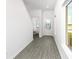 Bright entryway with grey wood-look flooring, half bathroom, and stairway at 3740 Bergamot St, Lake Alfred, FL 33850