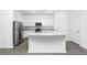 Modern kitchen with white cabinets, granite countertops, and stainless steel appliances at 3740 Bergamot St, Lake Alfred, FL 33850
