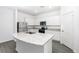 Modern kitchen with white cabinets, granite island, and stainless steel appliances at 3740 Bergamot St, Lake Alfred, FL 33850