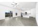 Open living room and kitchen with grey wood-look floors and sliding glass door at 3740 Bergamot St, Lake Alfred, FL 33850