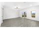 Spacious living room with grey wood-look floors and sliding glass doors at 3740 Bergamot St, Lake Alfred, FL 33850