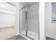 Modern shower with frameless glass enclosure and gray tile at 3740 Bergamot St, Lake Alfred, FL 33850