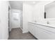 Modern bathroom with double vanity, grey flooring, and a walk-in shower at 3732 Bergamot St, Lake Alfred, FL 33850