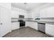 Modern kitchen featuring white cabinets, granite countertops, and stainless steel appliances at 3732 Bergamot St, Lake Alfred, FL 33850
