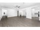 Open living room with gray vinyl flooring and access to kitchen and bathroom at 3732 Bergamot St, Lake Alfred, FL 33850