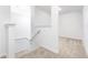 Upstairs hallway with neutral carpet and a staircase at 3732 Bergamot St, Lake Alfred, FL 33850
