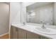 Bright bathroom featuring double sinks with modern hardware and a bathtub with shower at 4337 Hillock Blvd, Haines City, FL 33844