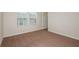 Cozy bedroom with natural light, carpeted floor, and an open doorway at 4337 Hillock Blvd, Haines City, FL 33844