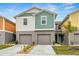 Charming two-story townhome featuring attached garages and colorful accents at 4337 Hillock Blvd, Haines City, FL 33844