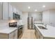Well-lit kitchen featuring modern stainless steel appliances and sleek countertops at 4337 Hillock Blvd, Haines City, FL 33844