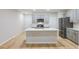 Open-concept kitchen with gray cabinetry, a large island, and stainless steel appliances at 4337 Hillock Blvd, Haines City, FL 33844