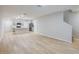 Open-concept living area featuring hardwood floors and a modern kitchen with stainless steel appliances at 4337 Hillock Blvd, Haines City, FL 33844