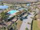 Community pool and tennis courts with surrounding landscape at 4204 Sevan Way, Kissimmee, FL 34746