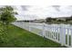White vinyl fence borders a grassy backyard by the water at 4204 Sevan Way, Kissimmee, FL 34746