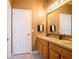 Double vanity bathroom with a large mirror and tile floors at 4204 Sevan Way, Kissimmee, FL 34746