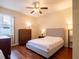 Spacious bedroom with a queen bed, dresser, and hardwood floors at 4204 Sevan Way, Kissimmee, FL 34746