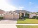 Beautiful two-story home with a large front yard and two-car garage at 4204 Sevan Way, Kissimmee, FL 34746
