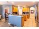 Open kitchen with granite countertops, oak cabinets, and an island at 4204 Sevan Way, Kissimmee, FL 34746