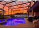 Stunning sunset view over a beautifully lit pool and spa at 4204 Sevan Way, Kissimmee, FL 34746