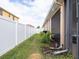 Landscaped side yard with a privacy fence at 4204 Sevan Way, Kissimmee, FL 34746