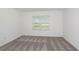 Serene bedroom with plush carpeting, a bright window, and neutral walls, creating a cozy and inviting retreat at 9080 Wildlight Trl, Wildwood, FL 34785