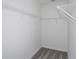 Walk-in closet with white walls, gray carpet, and multiple wire shelving units for optimal storage at 9080 Wildlight Trl, Wildwood, FL 34785