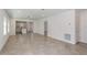 Open living room with tile flooring, recessed lighting, and a view into the kitchen, making it perfect for modern living at 9080 Wildlight Trl, Wildwood, FL 34785