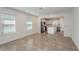 Bright living room with tile flooring, recessed lighting, and an open layout connecting to the kitchen, creating a welcoming space at 9080 Wildlight Trl, Wildwood, FL 34785