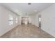 Bright living room with tile flooring, recessed lighting, and an open layout connecting to the kitchen, creating a welcoming space at 9080 Wildlight Trl, Wildwood, FL 34785